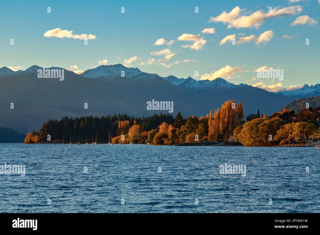 Lake Wanaka, New Zealand, in autumn. The last rays of the sun light up ...