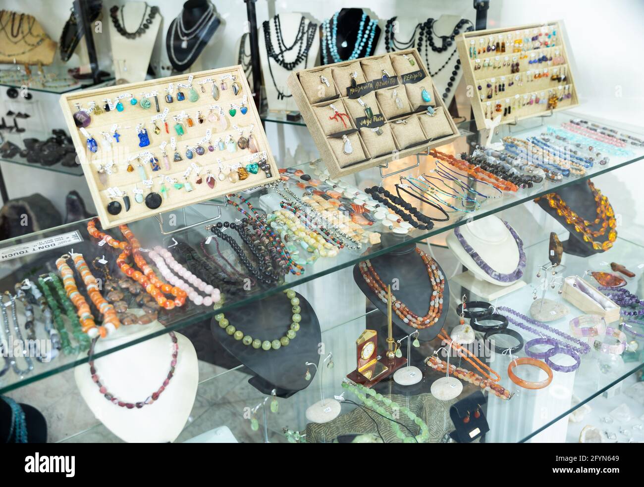 Showcase with natural stone jewelry in jewelry shop Stock Photo Alamy