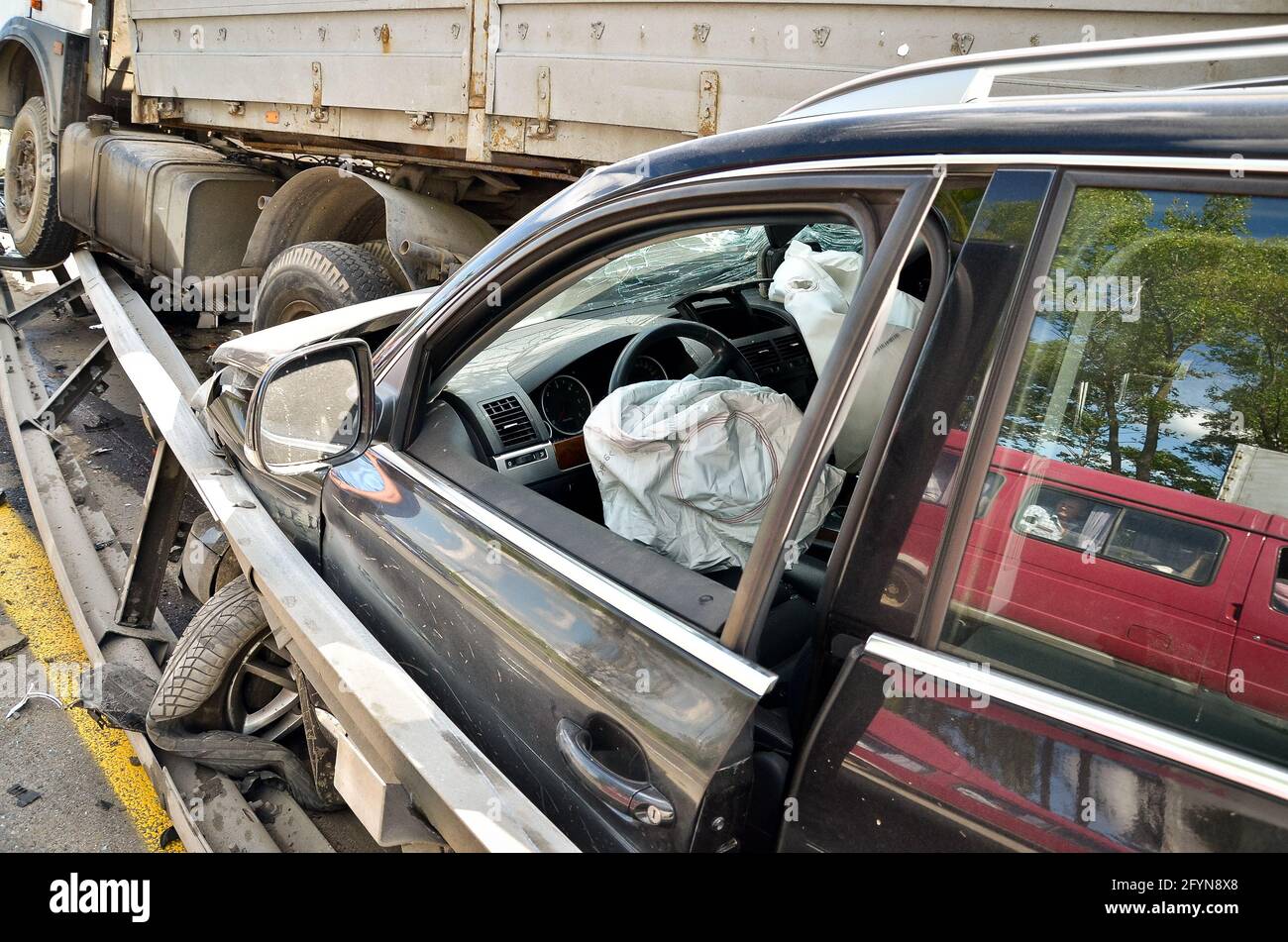 Close-up, car accident on a bypass road. Renault Tuareg car after a collision with MAZ.  Stock Photo