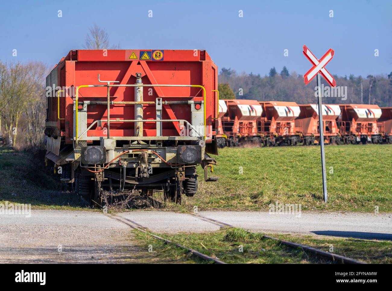 A standing freight train composition on a track in the middle of a meadow Stock Photo