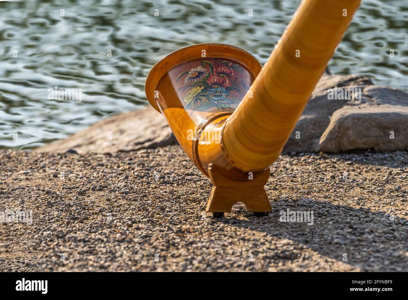 The musical instrument alphorn or alpenhorn or alpine horn is a labrophone, consisting of a straight several meter long wooden natural horn of conical Stock Photo