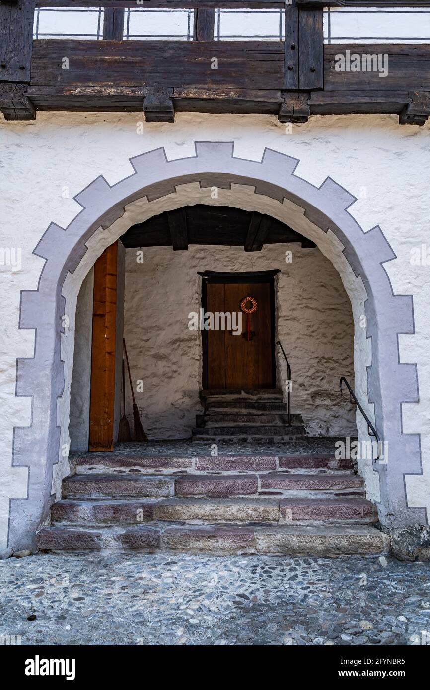 House door under the decorated arch of the traditional medieval house of Werdenberg, Switzerland Stock Photo