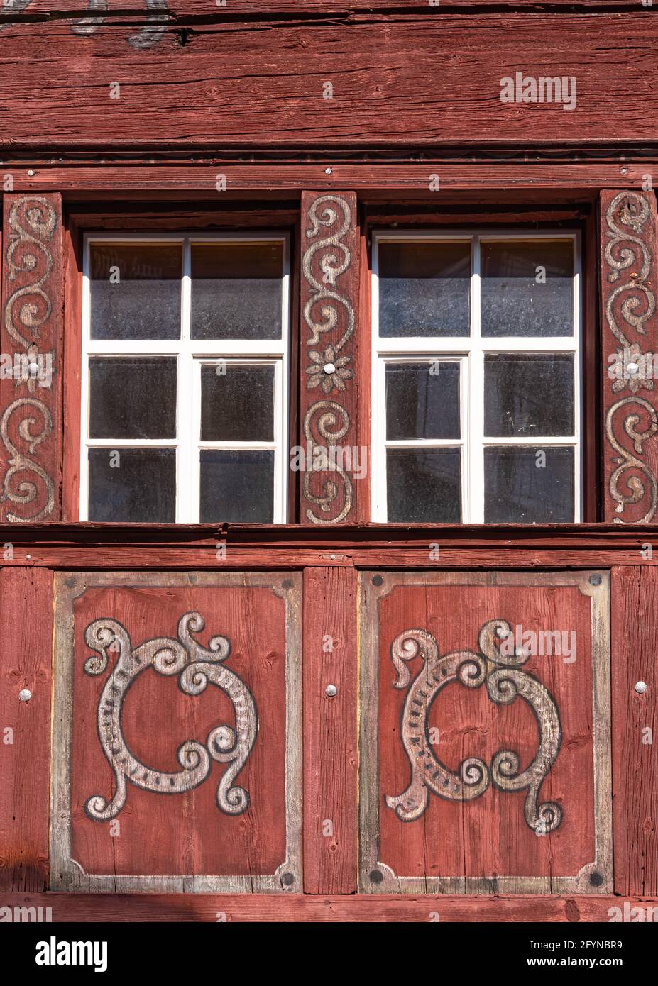 Close up of decorated windows of a wooden medieval house in Werdenberg, Switzerland Stock Photo