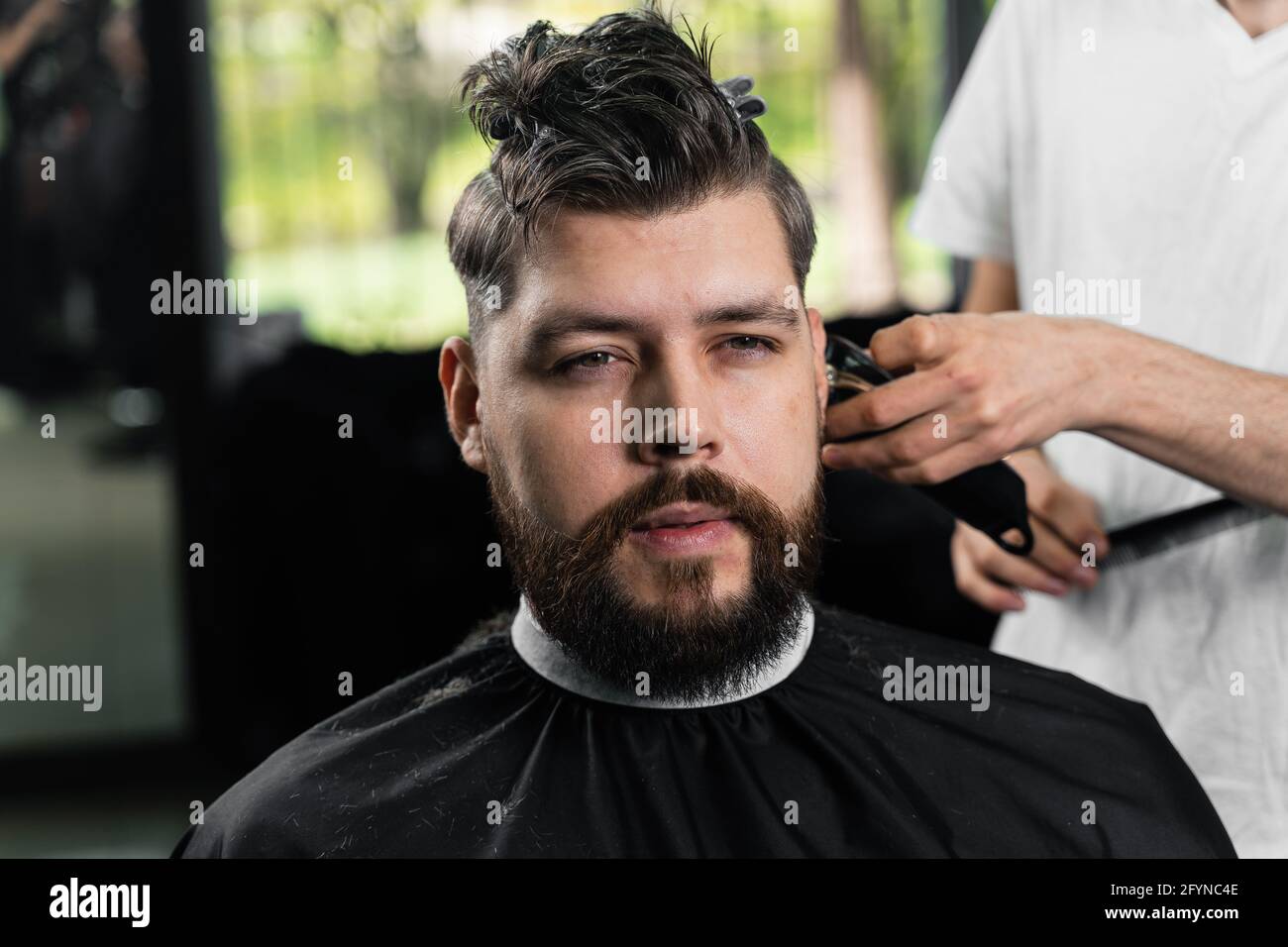 Low fade machine haircut for handsome bearded man in barbershop. Hair cut  with a smooth transition Stock Photo - Alamy