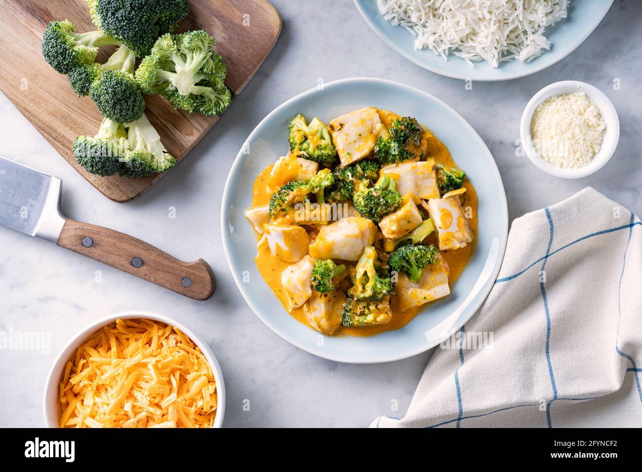Delicious baked fish with broccoli and cheddar cheese. Stock Photo