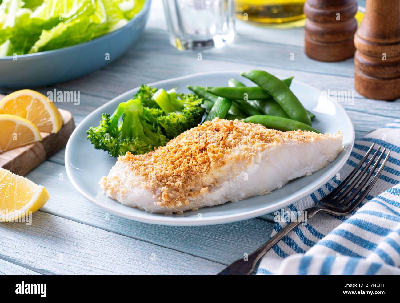Delicious oven baked fish with a crumbled cracker crust. Stock Photo