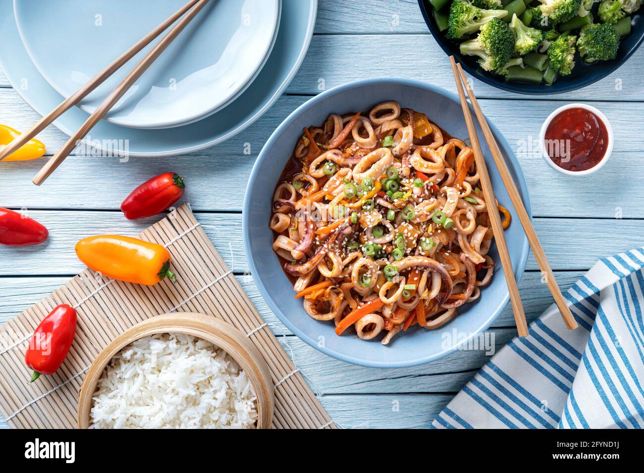 Delicious spicy stir fried calamari with peppers, scallion and sesame seed. Stock Photo