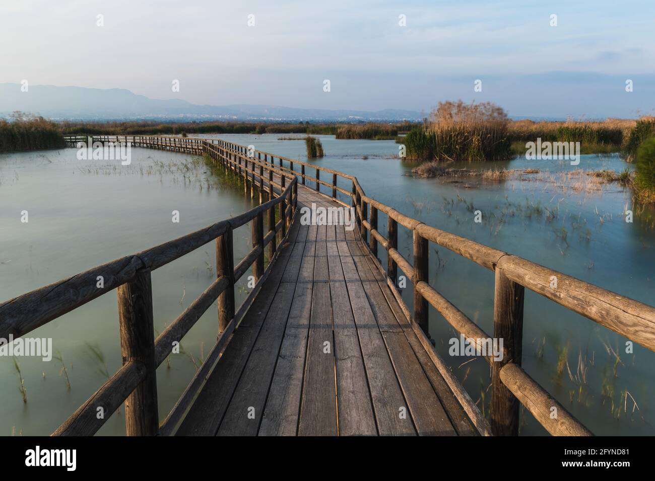 Long wooden bridge over a lake Stock Photo - Alamy