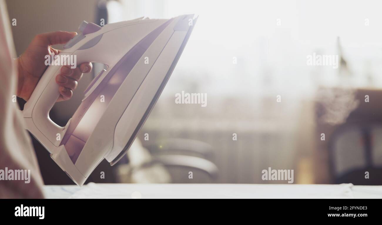 Woman uses irons, ironing at home Stock Photo Alamy
