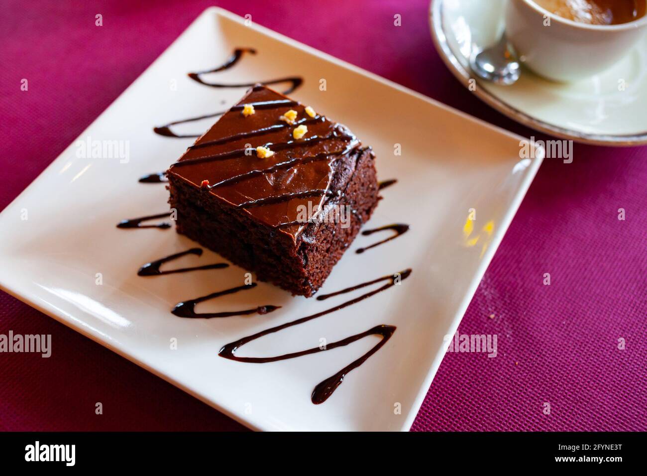 Piece of chocolate cake served on the white plate Stock Photo - Alamy