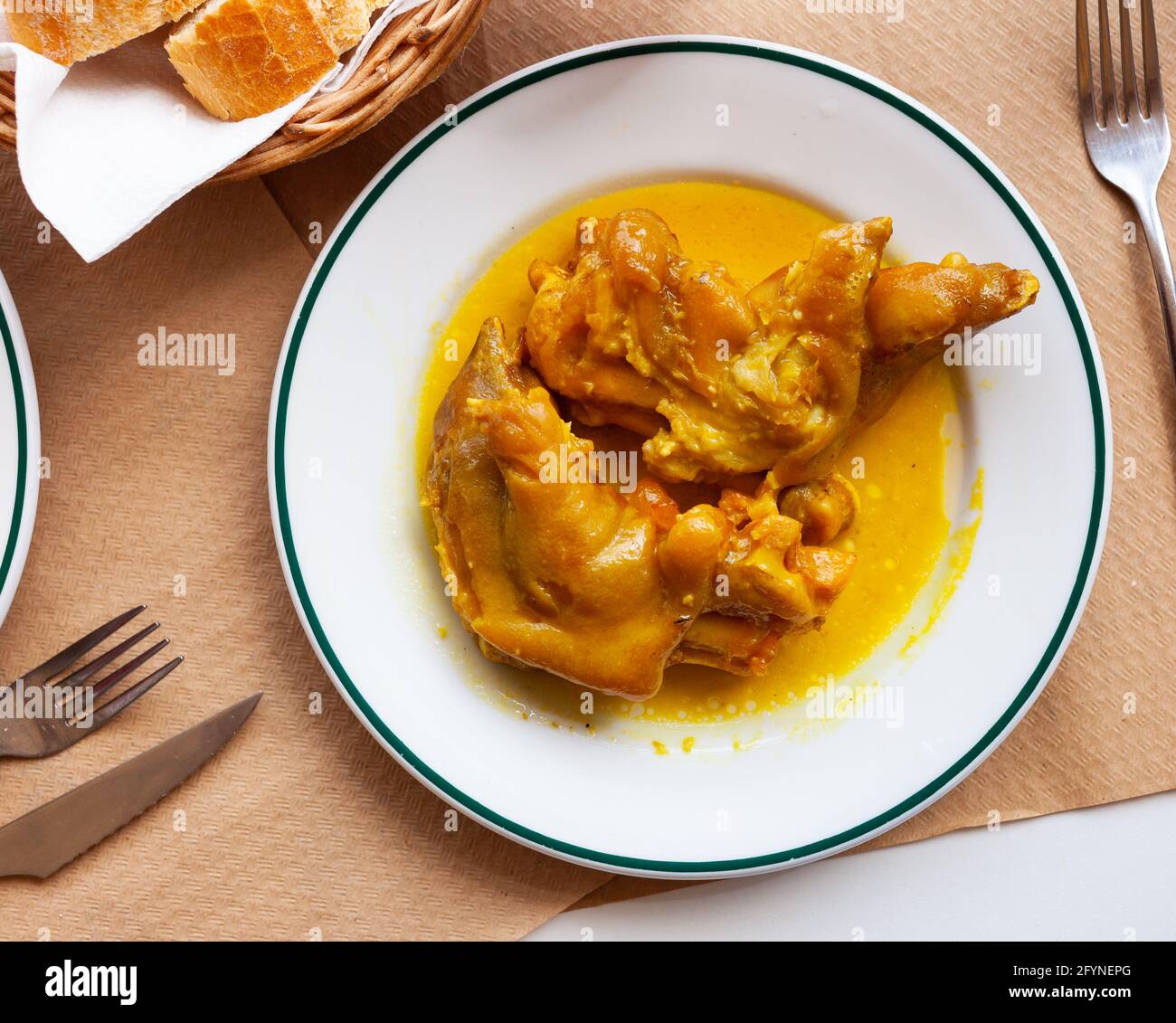 Traditional Spanish braised pettitoes, spicy pig feet cooked with sauce Stock Photo Alamy