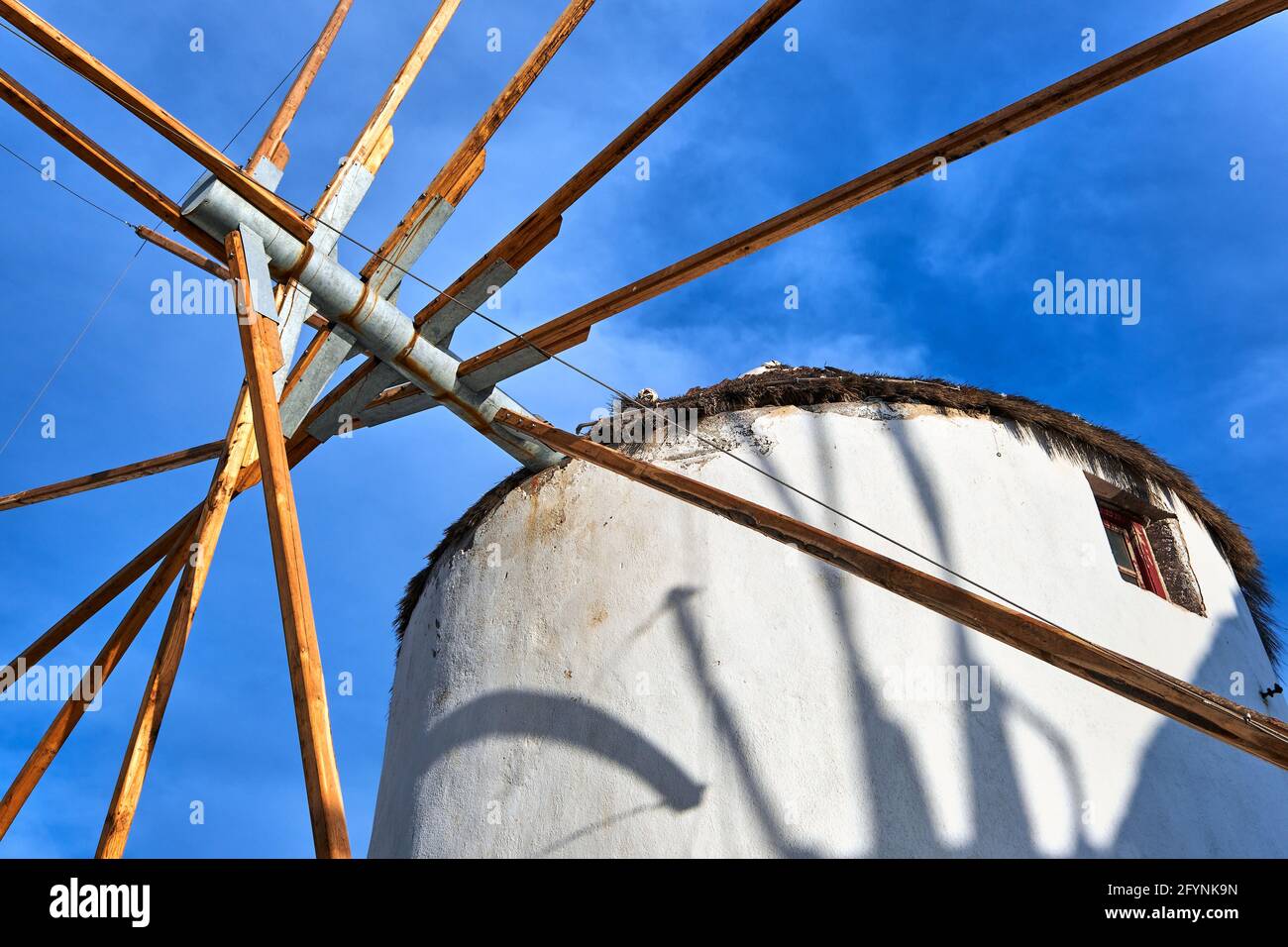 Famous tourist attraction of Mykonos, Greece. Traditional whitewashed windmill at clear blue sky. Summer, travel destination, upshot. Stock Photo