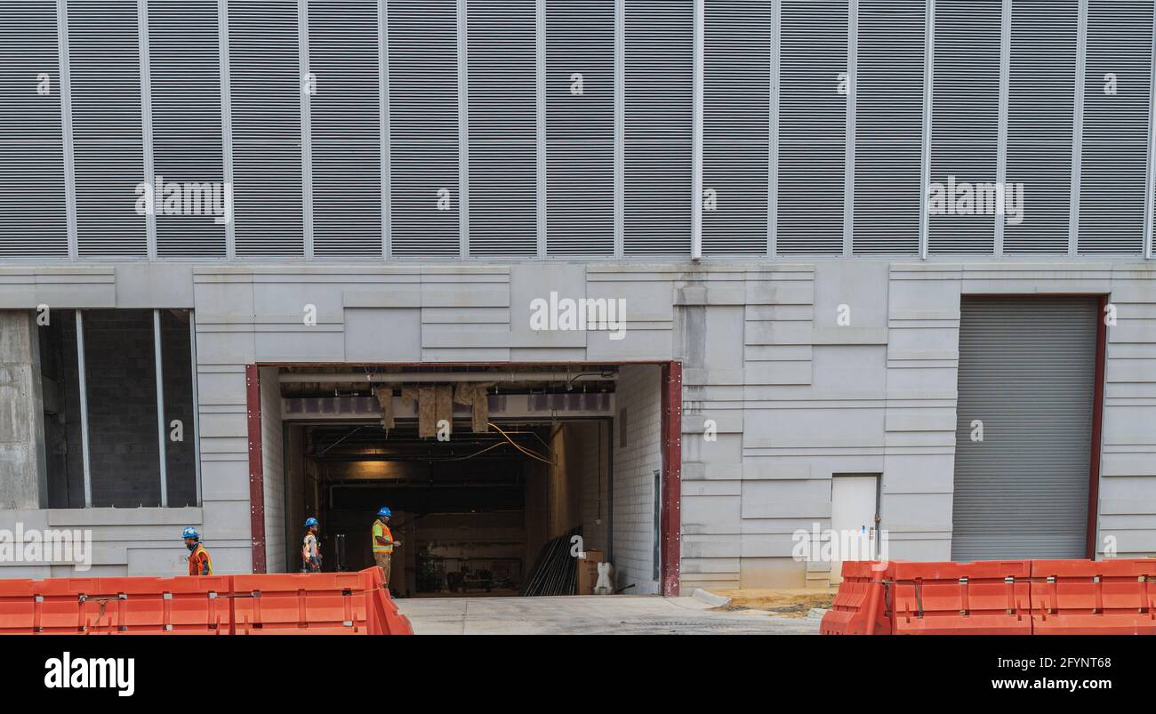 Reston, VA, USA -- May 21, 2021. Photo of hard-hatted workers at a construction site in Reston, VA. Stock Photo