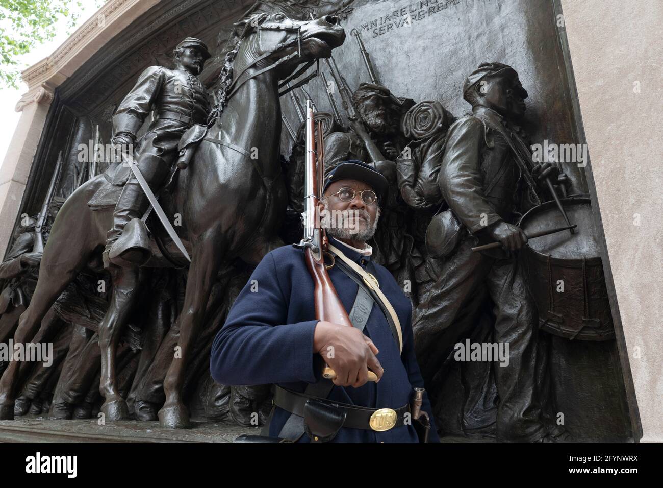 African American US Civil War soldier reenactor posing in front of the Robert Gould Shaw and the 54th Regiment Memorial, Boston Freedom Trail Stock Photo