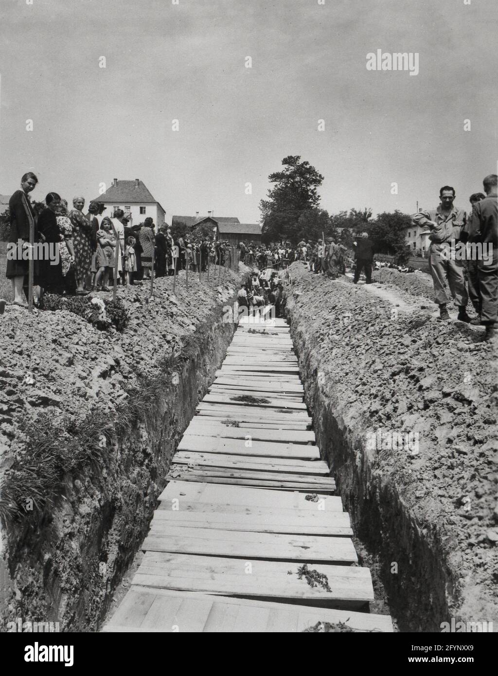 World War Two WWII Civilians of Nammering, Germany May 19, 1945 bury  800 victims of an SS killing three weeks prior in a mass grave Stock Photo