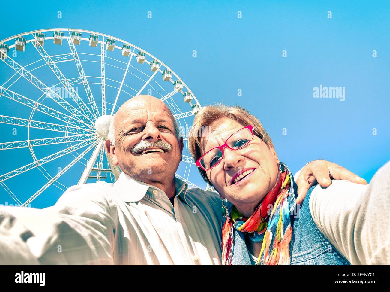 Happy retired senior couple taking selfie at travel around the world - Concept of active playful elderly with mobile phone Stock Photo