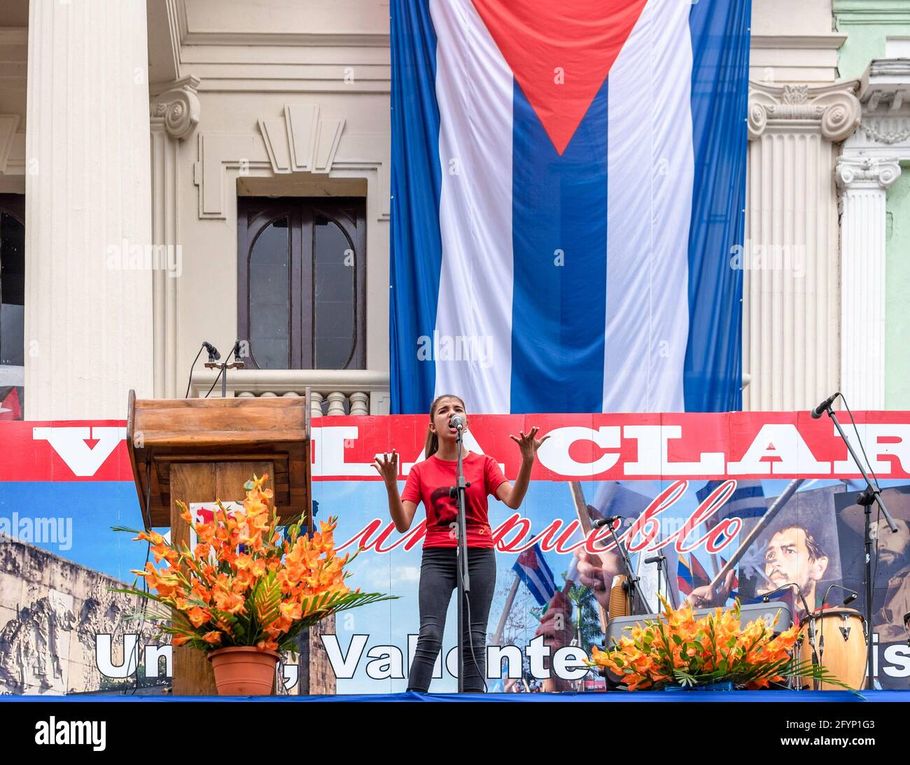 Santa Clara, Cuba-January 6, 2019:   Young teenager recites a poem in honor of Fidel Castro. She wears a Che Guevara T-shirt. Celebration of the Victo Stock Photo