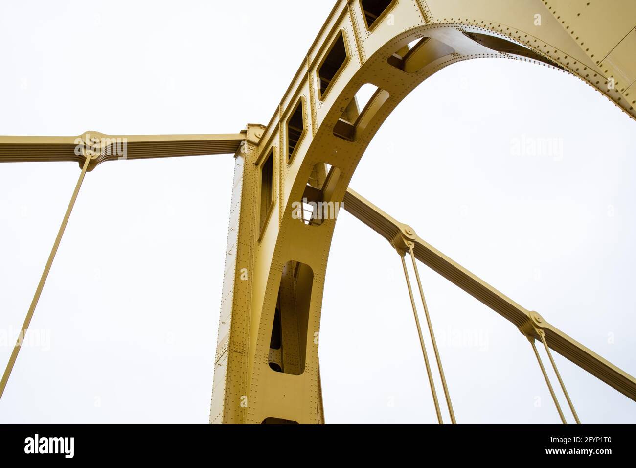 Structure of a self anchored suspension bridge seen from below painted