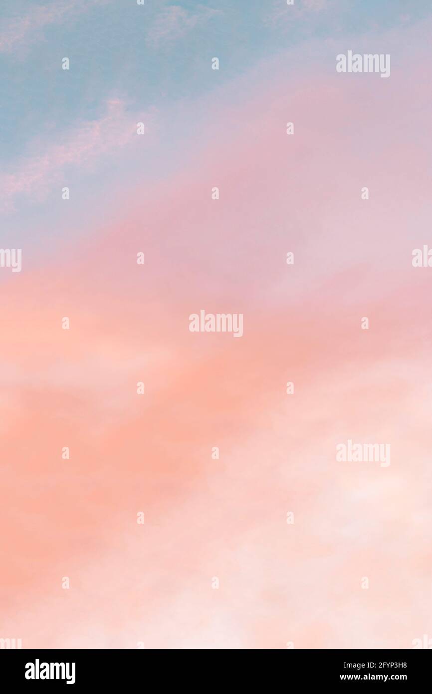 Vertical background formed by a bright pastel authentic sky during
