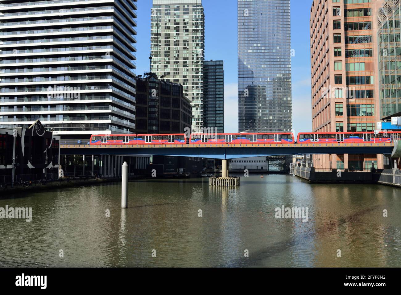 Docklands Light Railway (DLR) crossing south dock, Canary Wharf, Docklands, East London, United Kingdom Stock Photo
