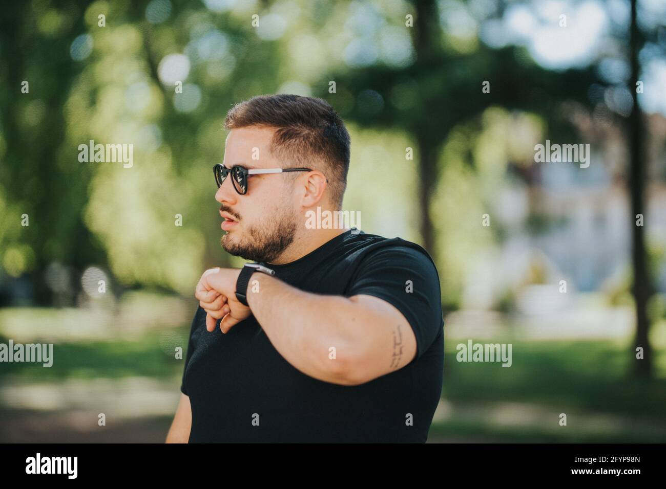 Male is using a voice command recorder on the smartwatch Stock Photo