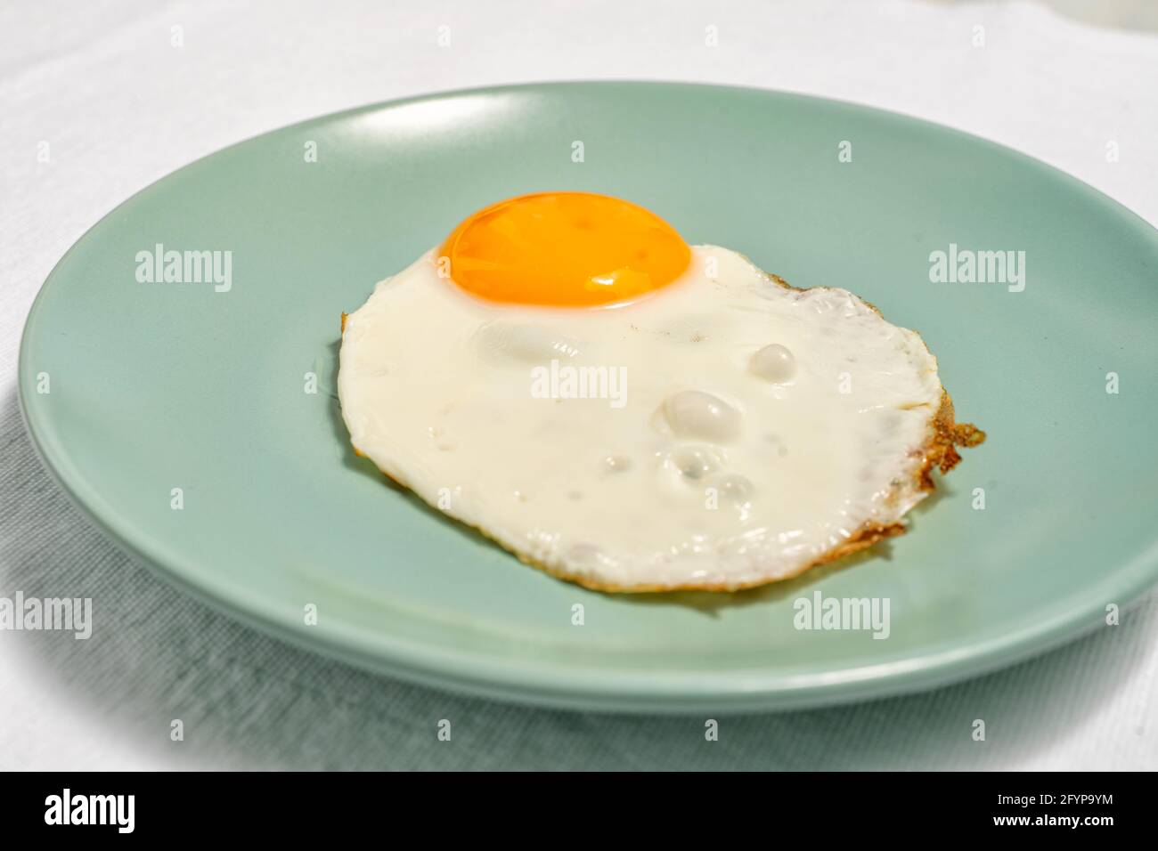 scrambled eggs on a blue plate close up. Stock Photo