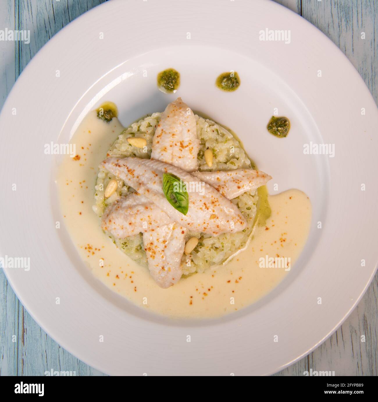 Baked sole fillet, risotto and pesto recipe Stock Photo