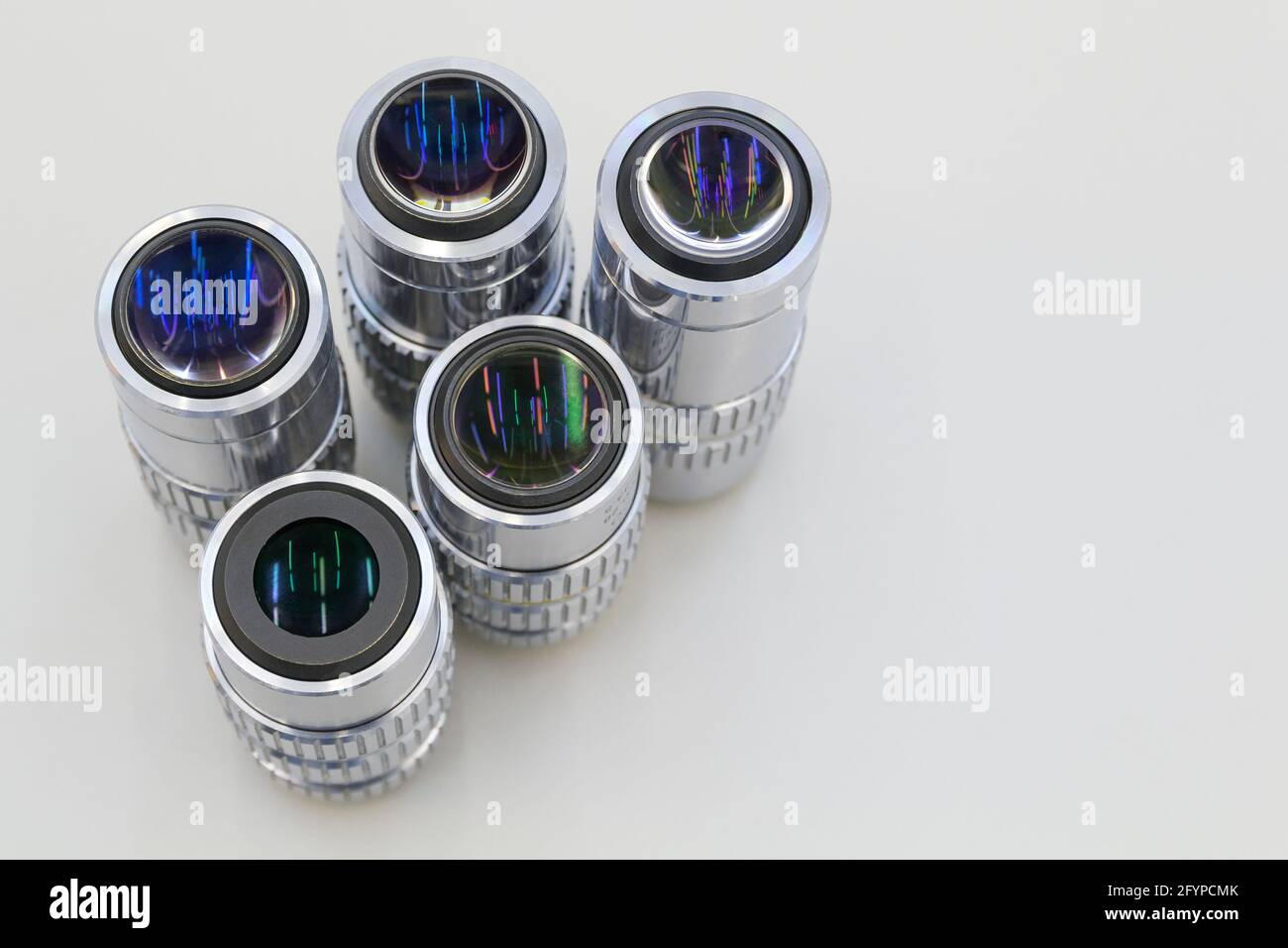 Many of lenses different of magnification on a white background. Close Up of microscope objectives. Stock Photo