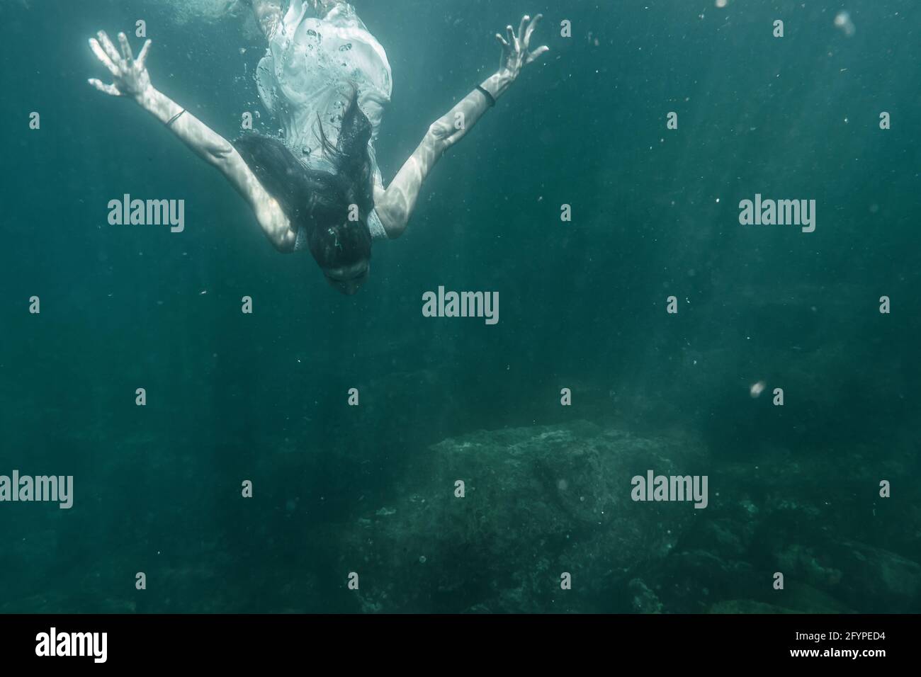 Young woman diving with a white dress diving Stock Photo Alamy