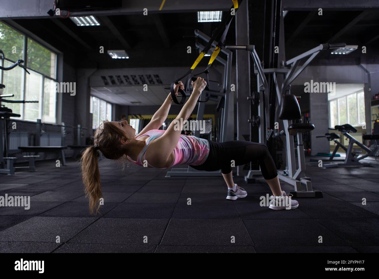 Female athlete ding low row exercise on trx trainer at the gym Stock Photo  - Alamy