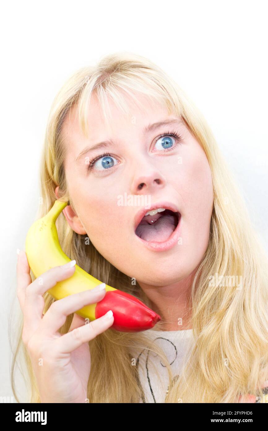 Nattering On A Banana A Female Phone Operator Shows Signs Of Being A Fruity Caller Stock Photo