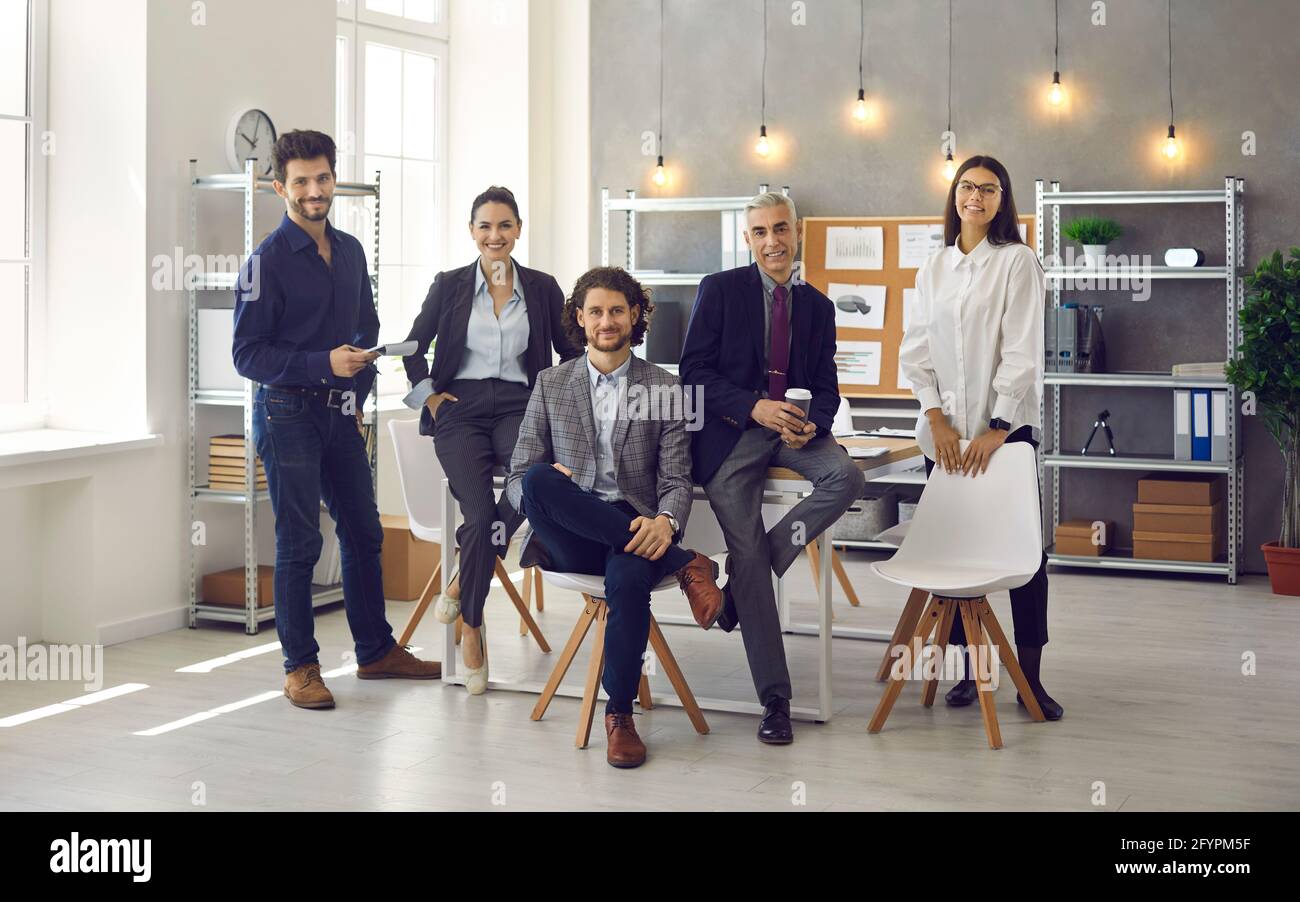 Group portrait of stylish successful business professionals in their modern office Stock Photo