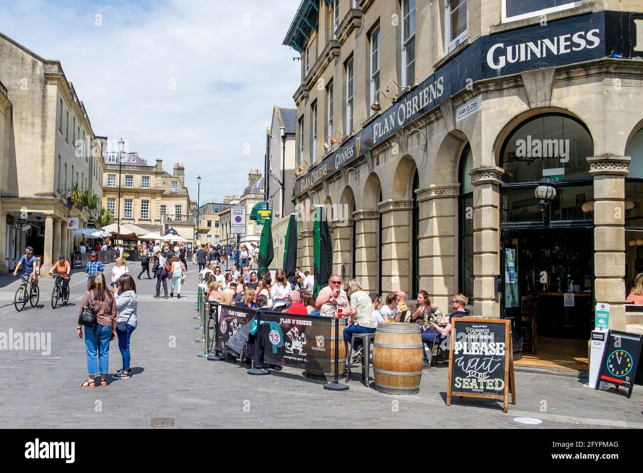 Bath, Somerset, UK. 29th May, 2021. Customers are pictured enjoying an afternnon drink outside Flann O' Brien's Irish Pub in the centre of Bath. Crowds of shoppers filled the streets as people made the most of the bank holiday weekend sunshine. Credit: Lynchpics/Alamy Live News Stock Photo