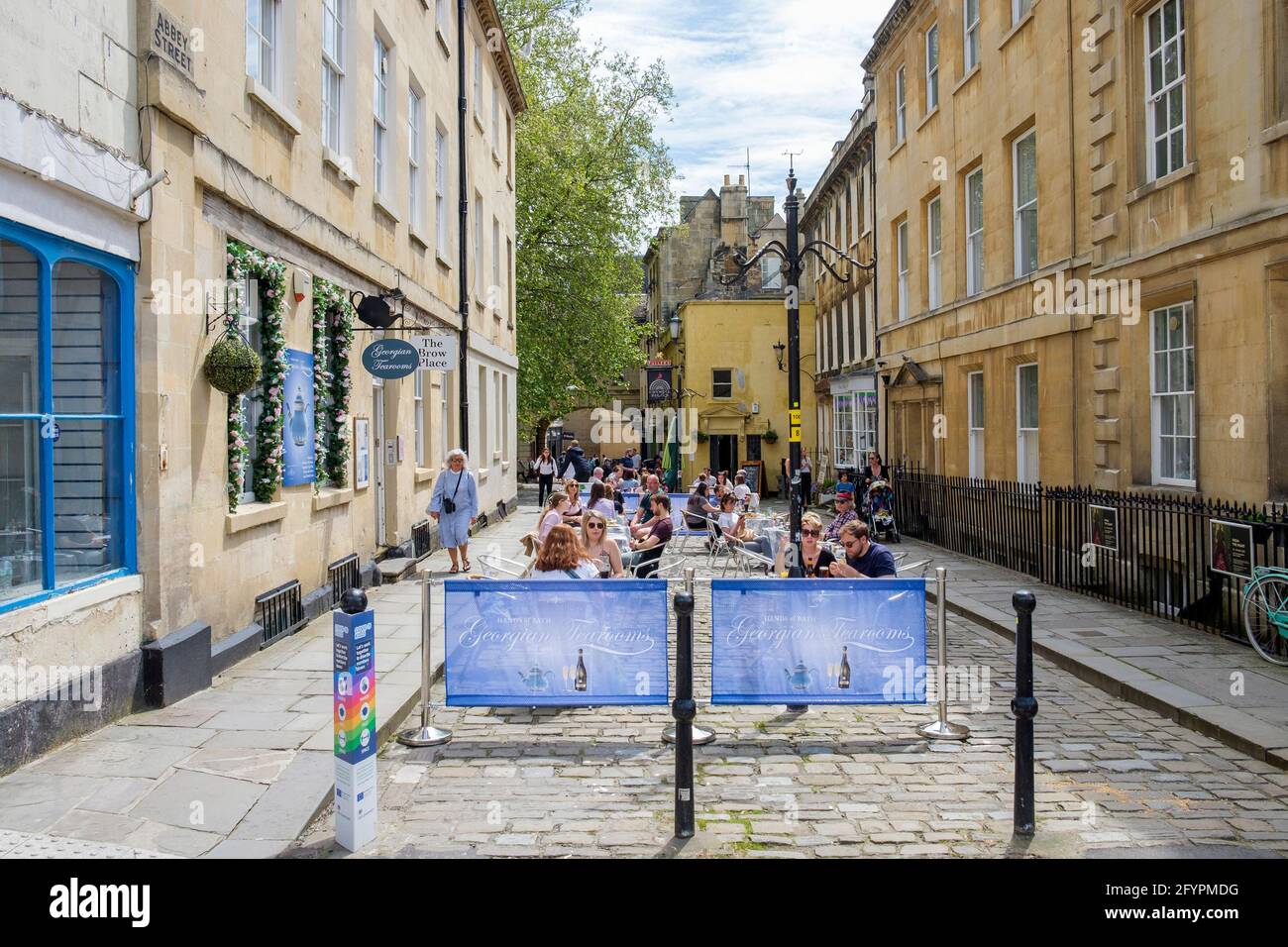Bath, Somerset, UK. 29th May, 2021. Customers are pictured sitting outside and enjoying an afternnon drink in the centre of Bath. Crowds of shoppers filled the streets as people made the most of the bank holiday weekend sunshine. Credit: Lynchpics/Alamy Live News Stock Photo