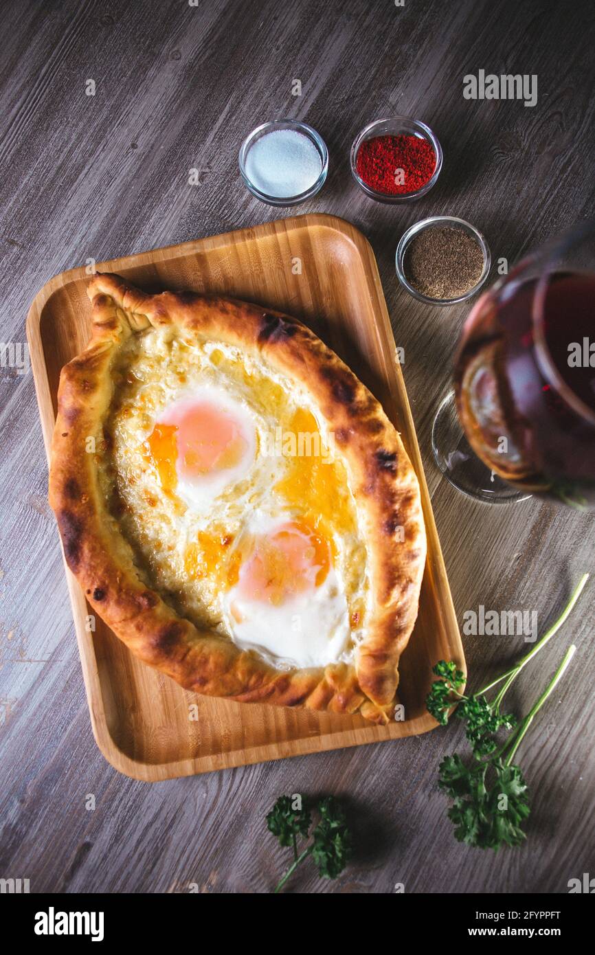flatbread with yam and cheese in the restaurant. Dish with wine and herbs Stock Photo