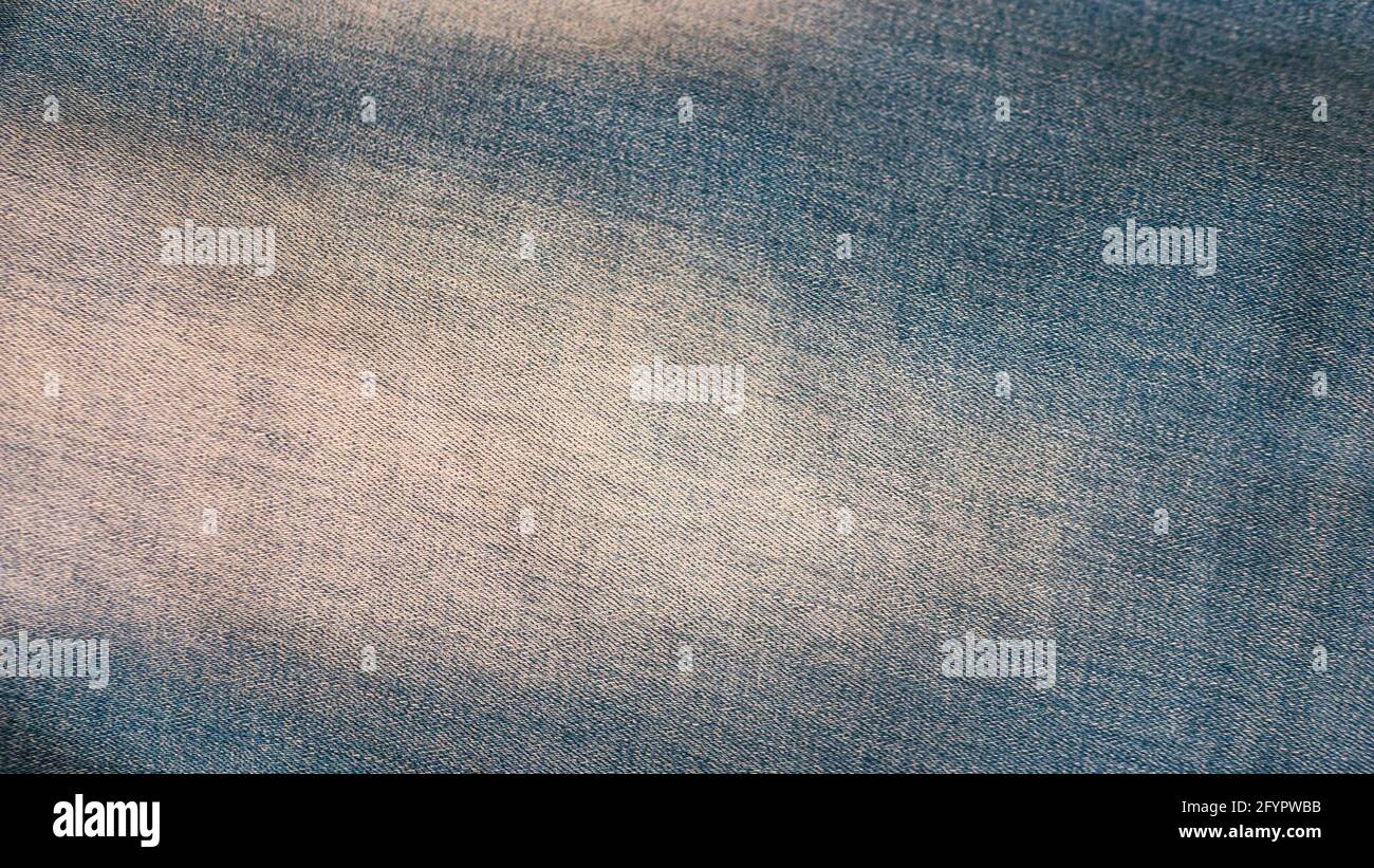 Denim background. Blue jeans with white spots closeup. Denim Stock
