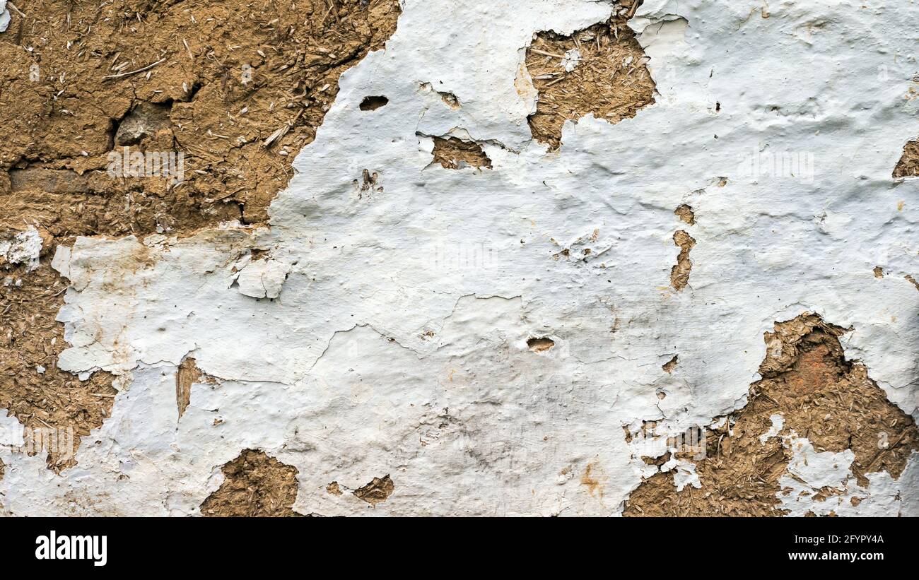An ancient wall of straw and white paint. Clay wall, clay huts. Antique texture. Stock Photo