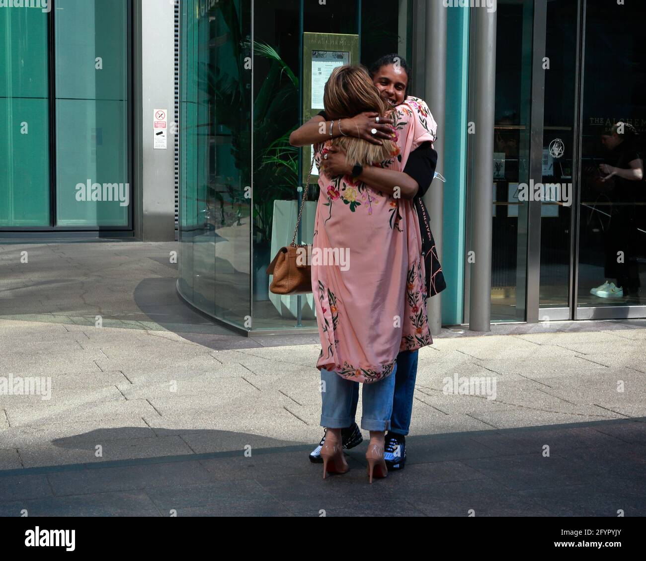 London (UK), 29 May 2021: People huge in the street Canary Wharf.Hugs allowed again in England from 17 May after lockdown restrictions begun to ease. Stock Photo
