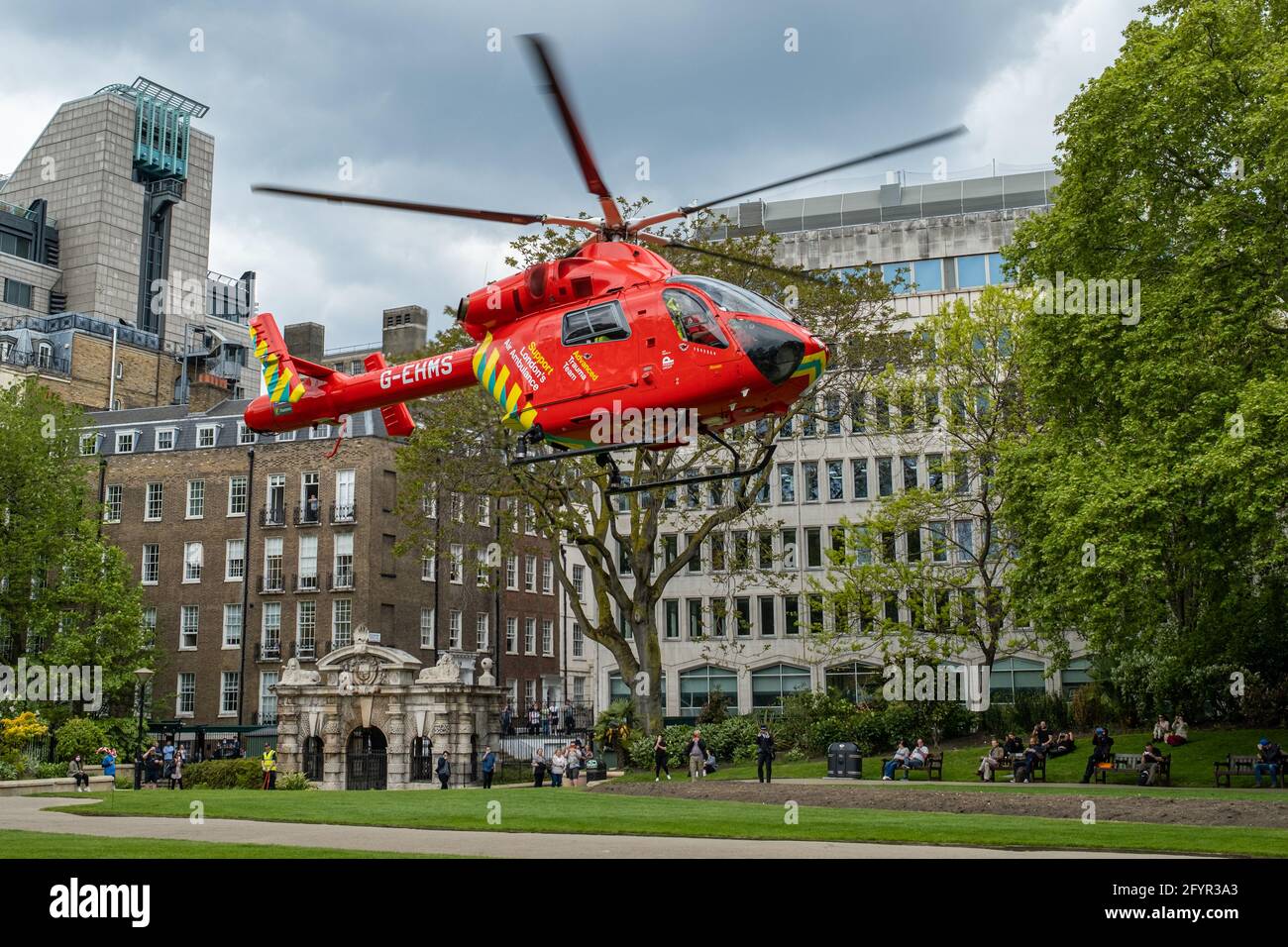 The London Air Ambulance lands in Victoria Embankment Gardens to assist with an incident on the River Thames Stock Photo