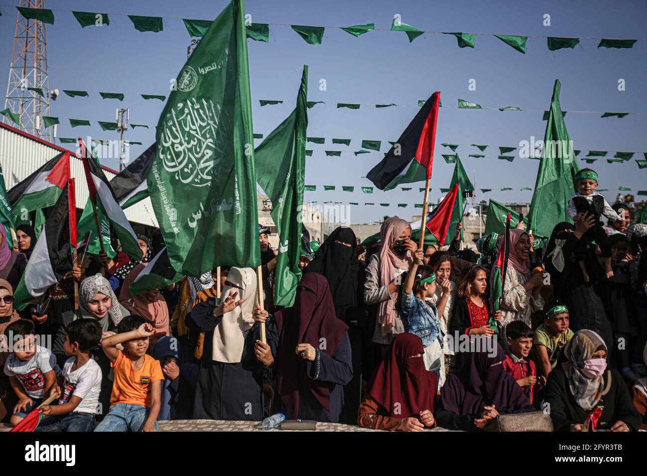 Gaza, Palestine. 29th May, 2021. Palestinian women chant with flags during an anti-Israel military parade by Izz al-Din al-Qassam Brigades in Rafah, in the southern Gaza Strip. Credit: SOPA Images Limited/Alamy Live News Stock Photo