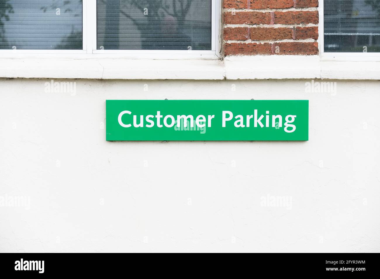 Customer parking only sign on car park staff gate at place of work Stock Photo