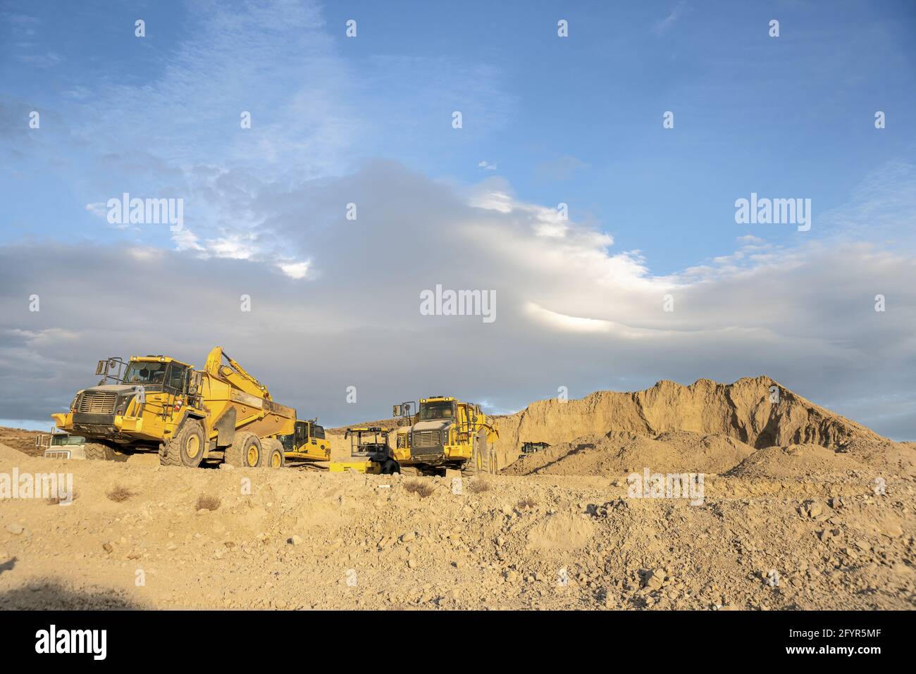 Construction site with heavy equipment under the cloudy blue sky Stock ...