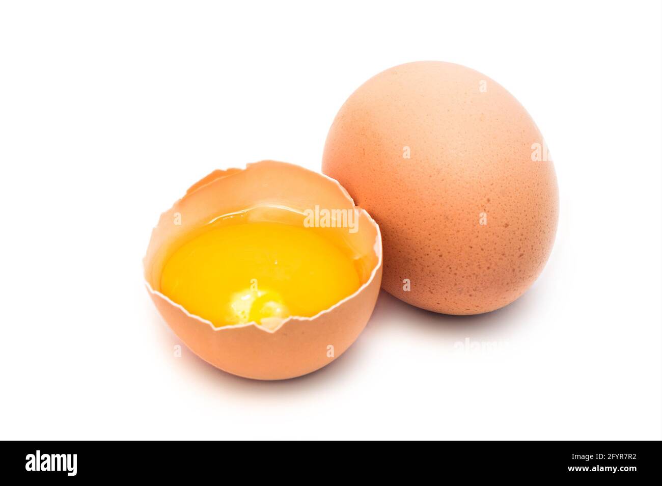 whole and broken hen eggs isolated Stock Photo
