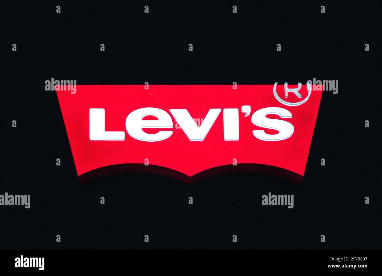 Levis storesign on dark background. Levi Strauss & Co, american manufacturer of jeans and clothes, since 1853 Stock Photo