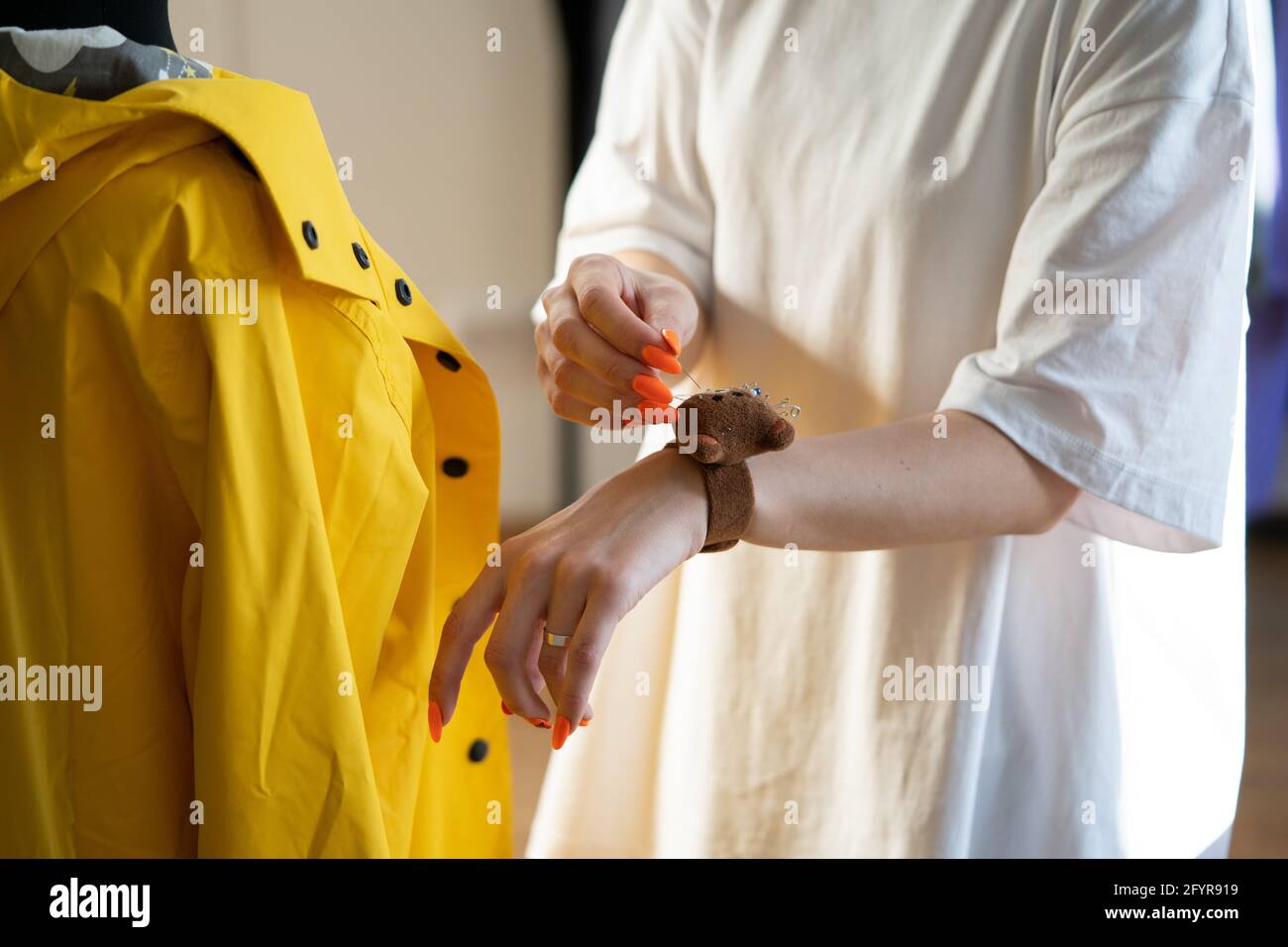 Tailor couturier measuring cloth. Closeup of sewer woman hands