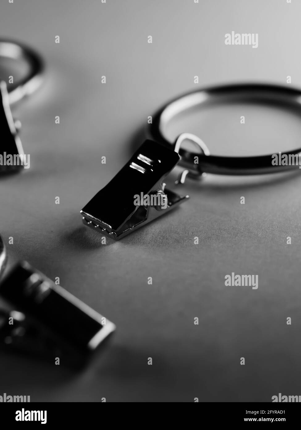 Dramatic grayscale shot of curtain metal rod clip rings Stock Photo Alamy