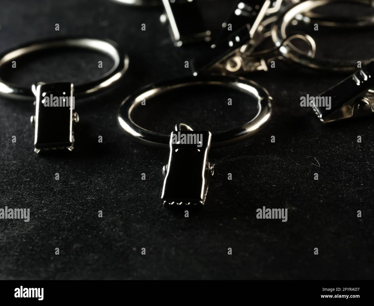 Dramatic grayscale shot of curtain metal rod clip rings Stock Photo Alamy