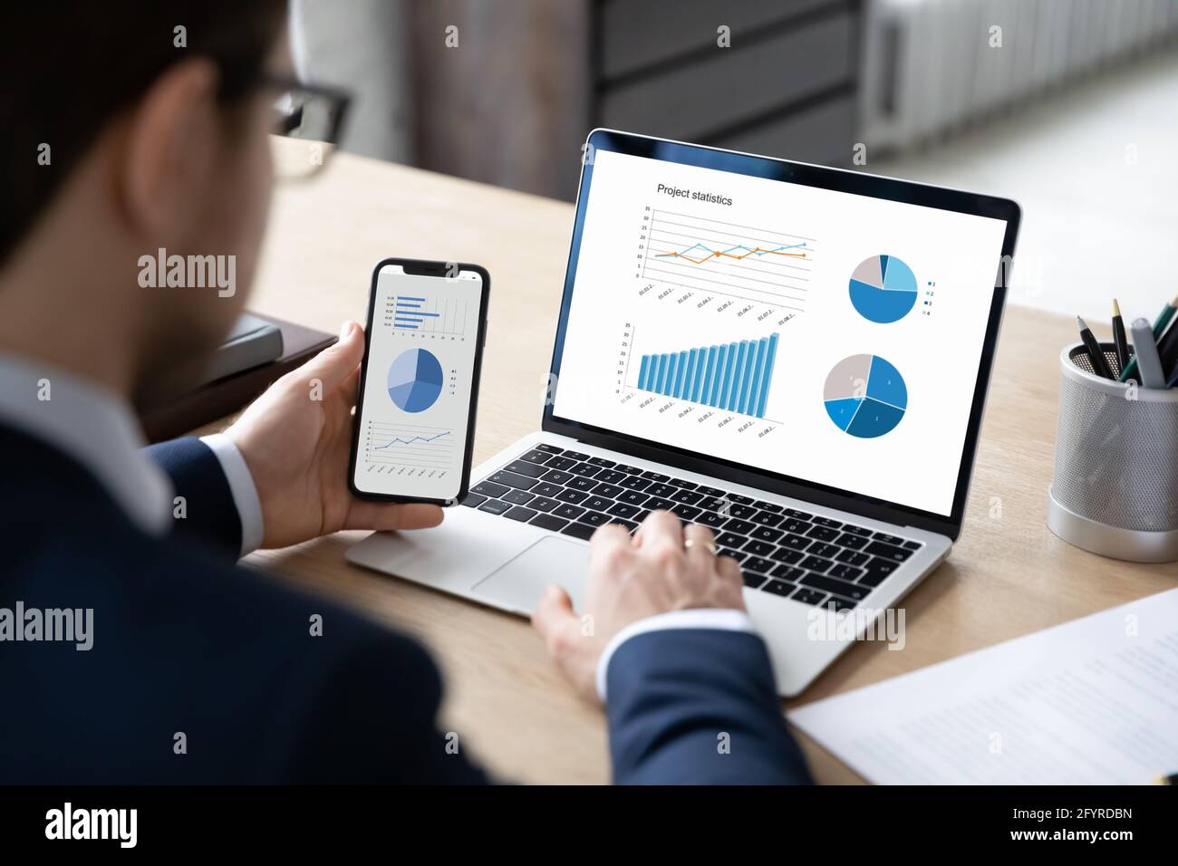 Business marketer using professional app for marketing data analyzing Stock Photo