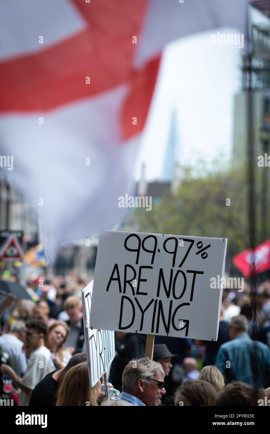 Manchester, UK. 29th May, 2021. A flag flyÕs over a placard at Parliament Square before the start of the protest. The number of people attending the protests has increased month on month since the introduction of the COVID-19 restrictions. Credit: Andy Barton/Alamy Live News Stock Photo