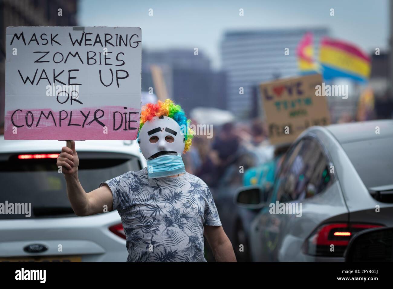 Manchester, UK. 29th May, 2021. A man with a placard blocks the road ahead of a anti-lockdown march. The number of people attending the protests has increased month on month since the introduction of the COVID-19 restrictions. Credit: Andy Barton/Alamy Live News Stock Photo